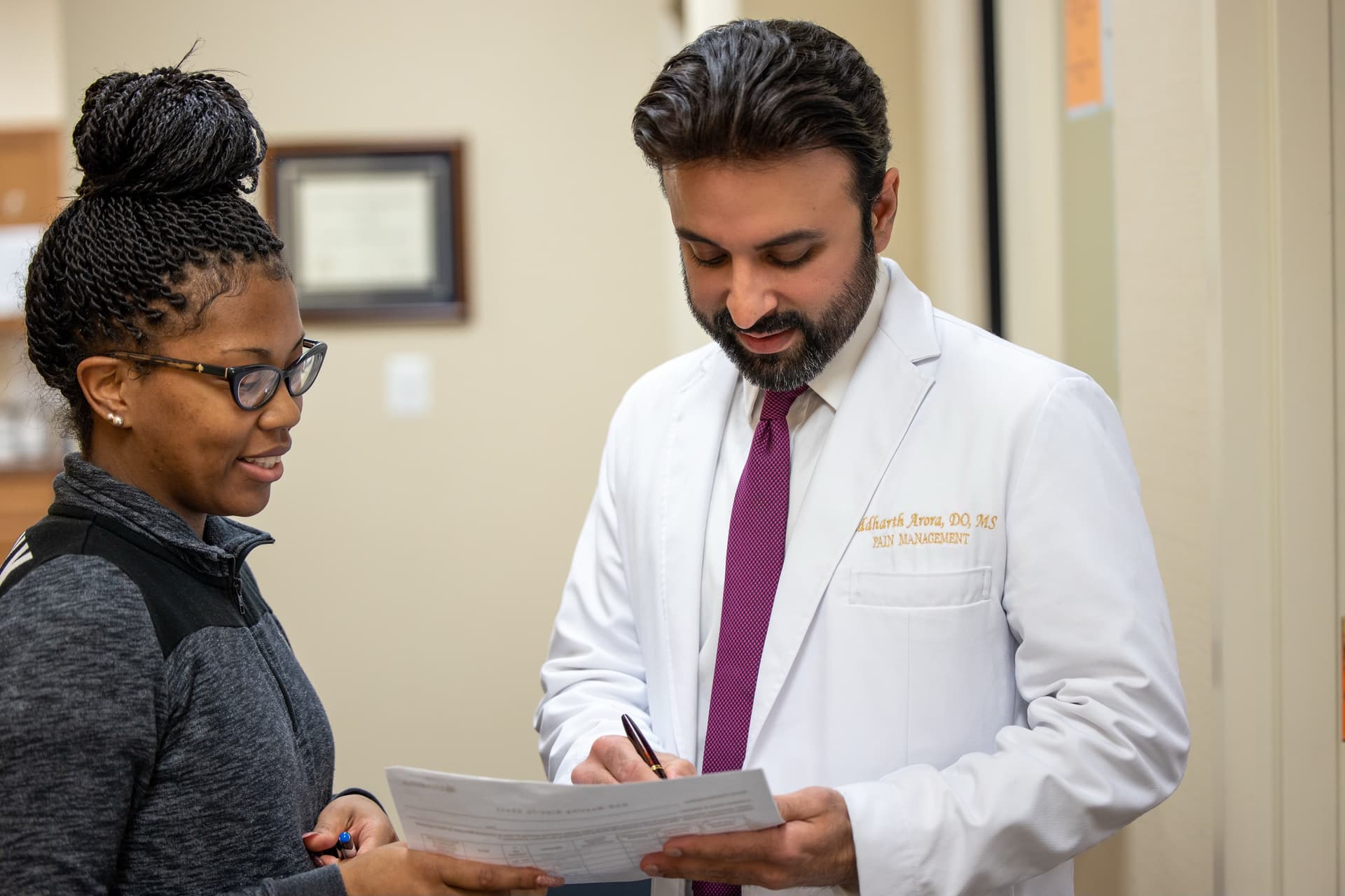 Two people reviewing paperwork together
