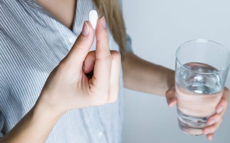 A woman taking a pill