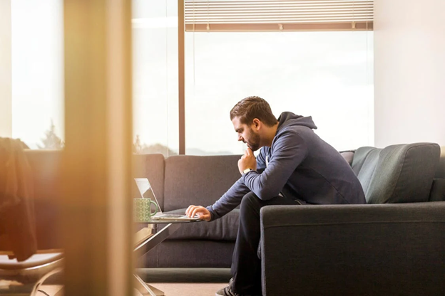 Man engaging in online mental health counseling from home, illustrating accessible mental health services.
