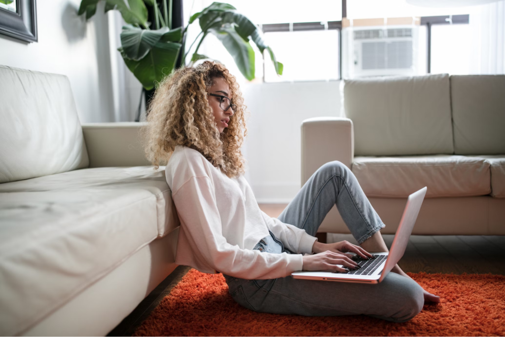 Young woman accessing online addiction treatment from her laptop at home.
