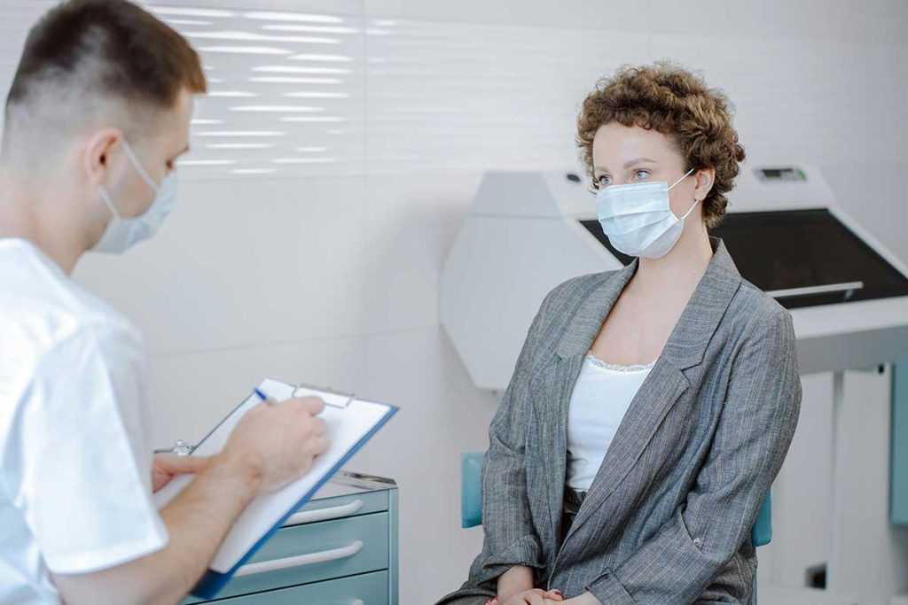 Patient discussing marijuana addiction treatment with healthcare provider in clinic. 