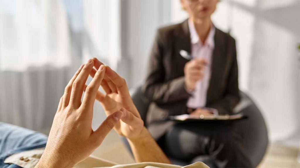 Patient talking to a therapist during a counseling session.