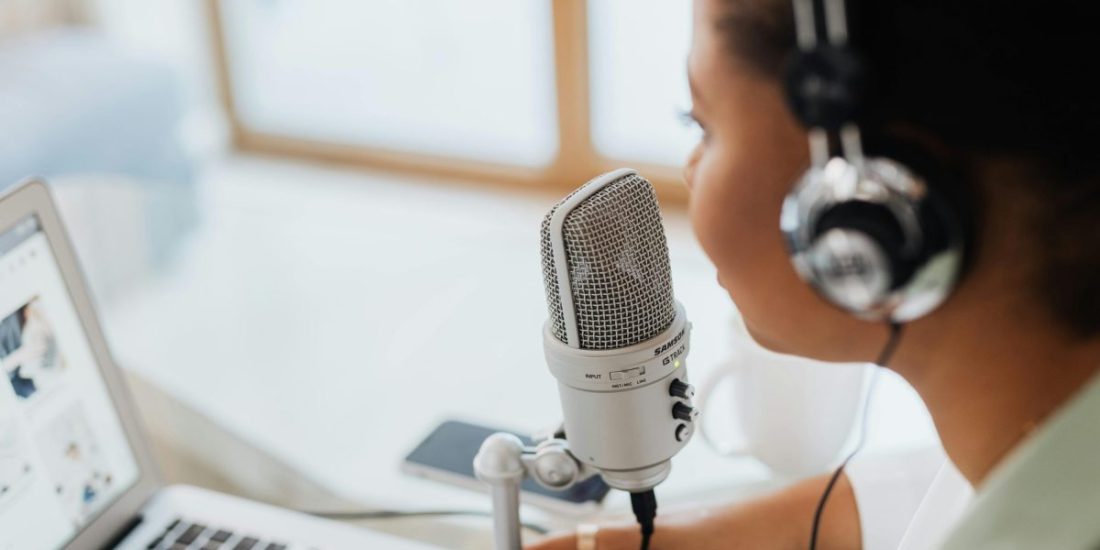 A woman recording a podcast
