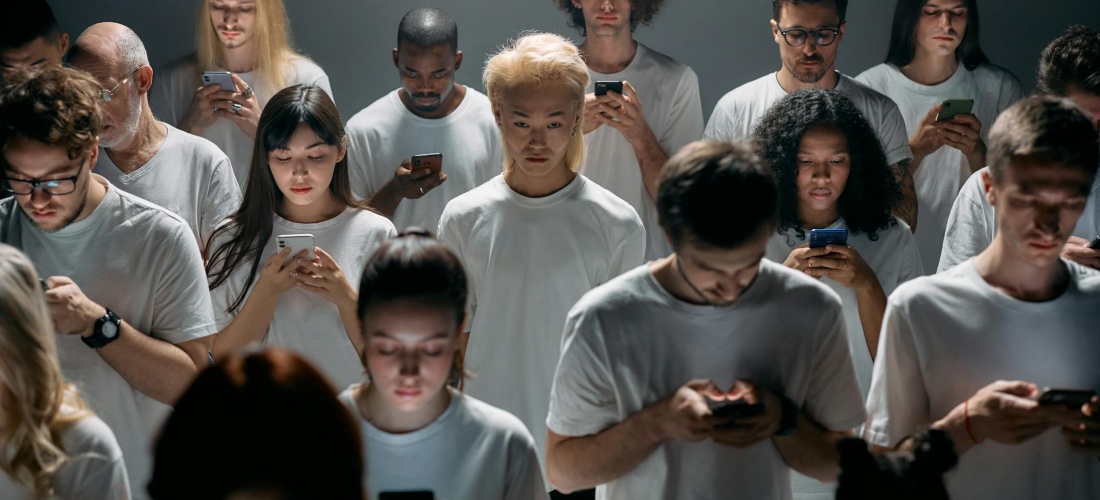 Many people looking at phone screens.