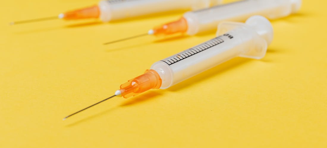 Syringes placed on a yellow surface