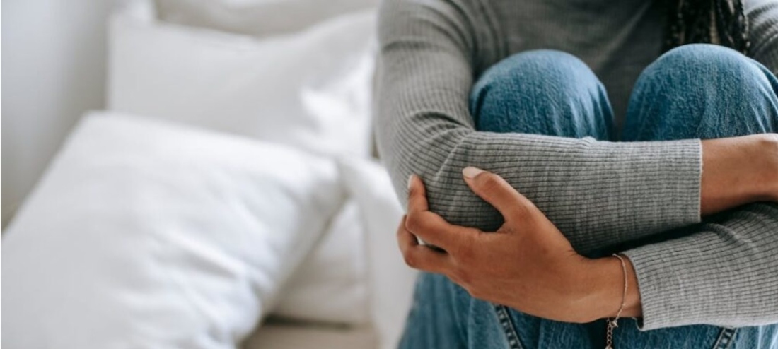 A woman hugging her knees