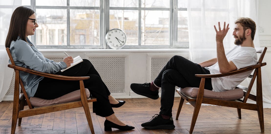 a therapist and a man talking about Maladaptive Coping Skills
