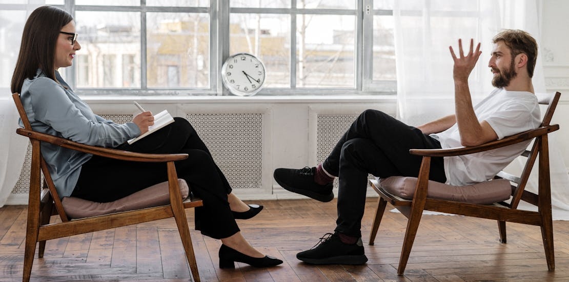 a man talking with a therapist