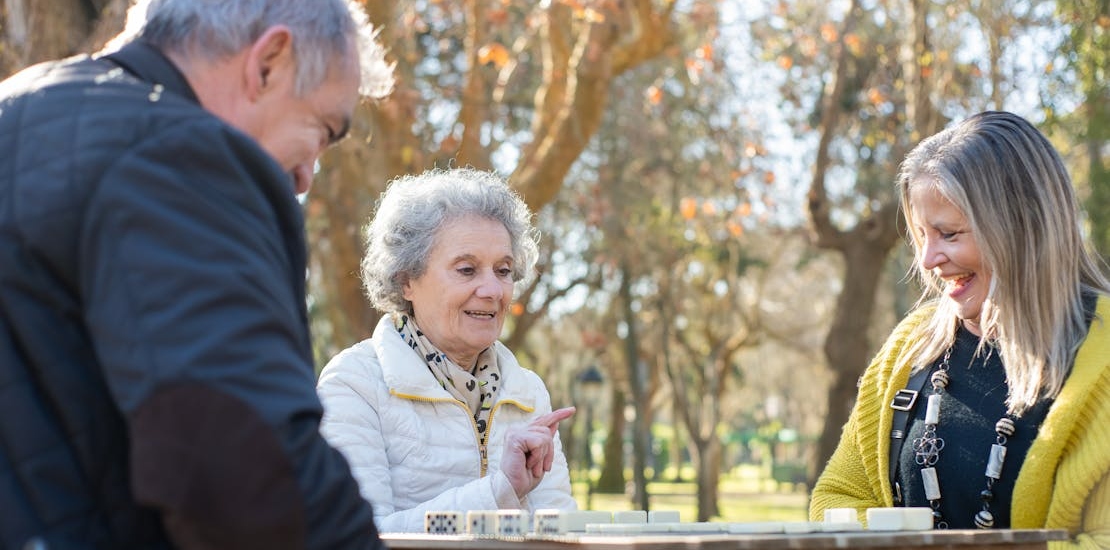 seniors in the park playing dominos