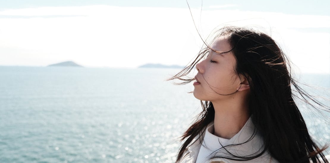 a woman with the wind in her hair experiencing the long-term benefits of quitting weed