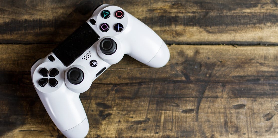 White Gaming Console on Wooden Surface