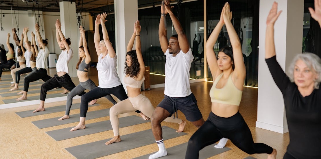 people doing yoga in a group class 