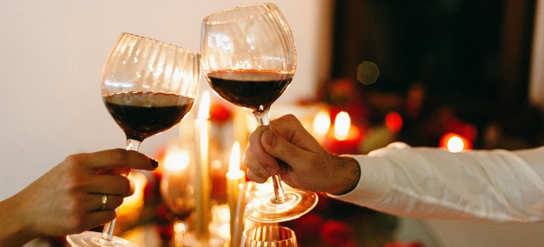 People toasting with glasses of wine.