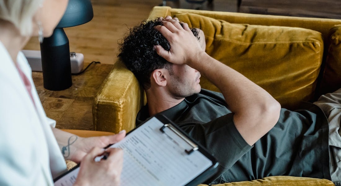 man lying on a sofa talking about Addiction and Mental Health Treatment in Nevada