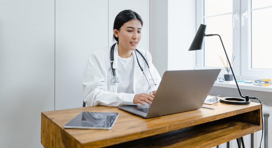 a doctor using a laptop